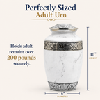 White marble adult cremation urn with silver floral bands and lid, shown with dimension labels reading 10 inches height and 6 inches diameter on a light beige background with promotional text.